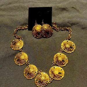 Matching sand dollar necklace and earrings.